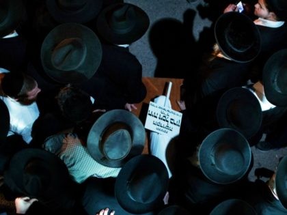 Ultra-orthodox Jewish mourners carry the body of three-month-old baby Chaya Zissel Braun during her funeral in Jerusalem on October 23, 2014 after she was killed in what Israeli police called a 'hit-and-run terror attack' when a Palestinian driver rammed a group of pedestrians. Nine others were injured in the attack. …