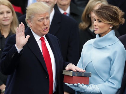 WASHINGTON, DC - JANUARY 20: (L-R) U.S. President Donald Trump takes the oath of office as his wife Melania Trump holds the bible and his son Barron Trump looks on, on the West Front of the U.S. Capitol on January 20, 2017 in Washington, DC. In today's inauguration ceremony Donald …