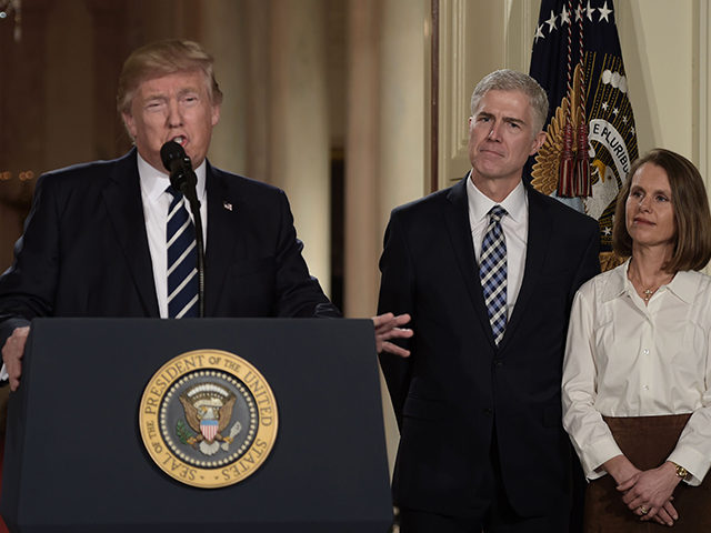 Judge Neil Gorsuch (C) and his wife Marie Louise look on, after US President Donald Trump