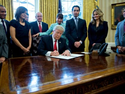 WASHINGTON, DC - JANUARY 30: (AFP OUT) U.S. President Donald Trump signs an executive orde