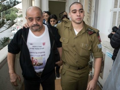 Israeli soldier Elor Azaria (R), who was caught on video shooting a wounded Palestinian assailant in the head as he lay on the ground, arrives with his father for a hearing at a military appeals court in Tel Aviv on November 23, 2016. / AFP / JACK GUEZ (Photo credit …