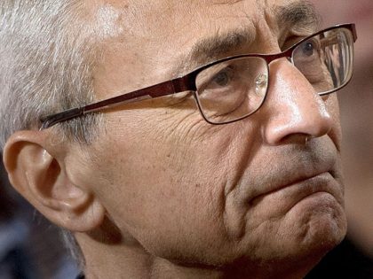 John Podesta, Clinton campaign chairman who believes his elitist strategy only lost because of Russian hacking, listens as former Democratic US Presidential candidate Hillary Clinton speaks to supporters at the New Yorker Hotel after her defeat in the presidential election November 9, 2016 in New York. / AFP / Brendan …