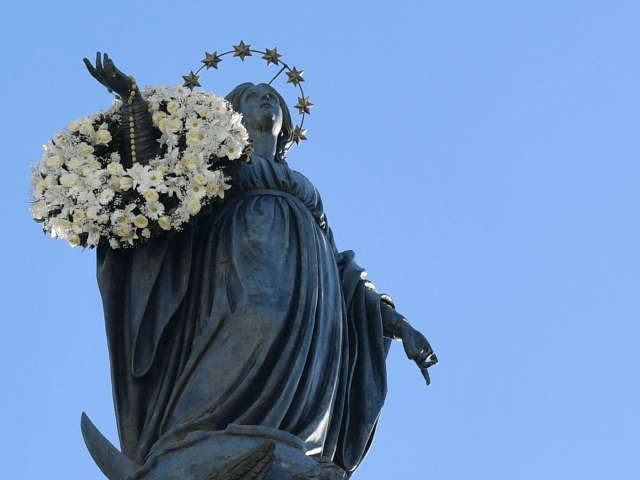 A seagull flies near the statue of the Virgin Mary during the annual feast of the Immacula