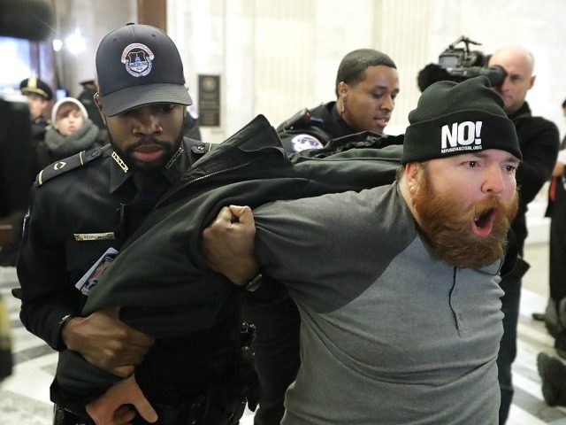 A protester shouts, 'No Trump, No KKK, No facist USA' as he is hauled out of the Senate Judiciary Committee's confirmation hearing for Sen. Jeff Sessions (R-AL) to be the next U.S. Attorney General in the Russell Senate Office Building on Capitol Hill January 10, 2017 in Washington, DC.
