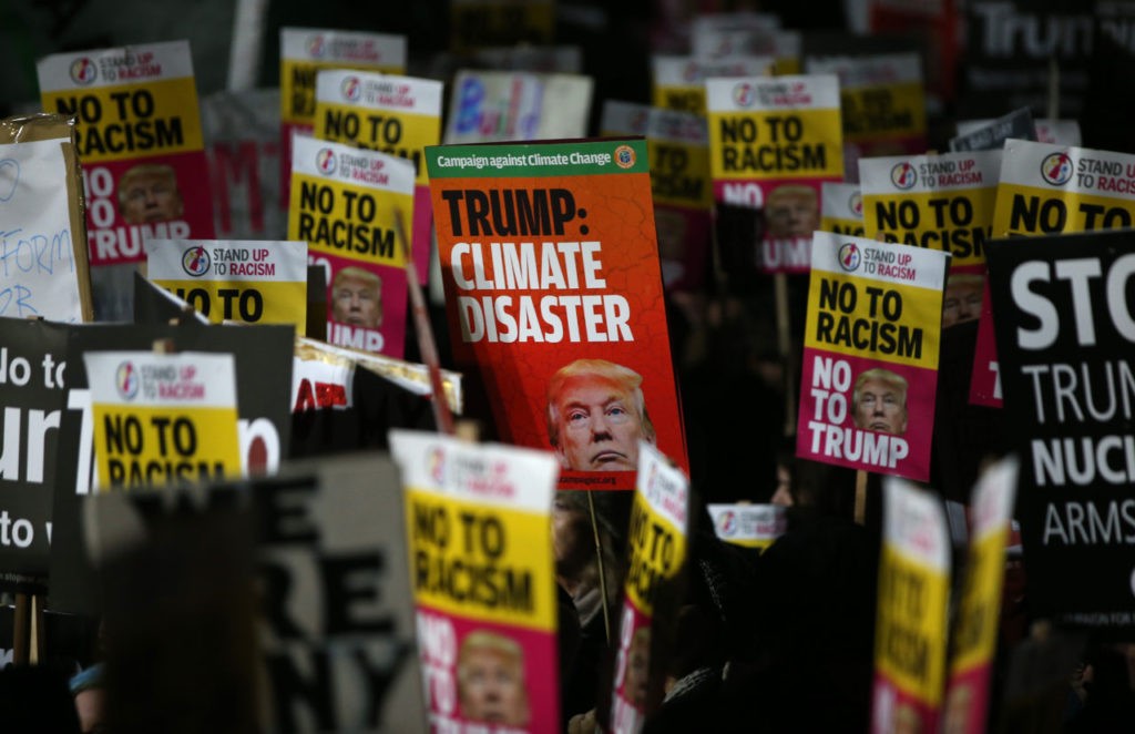 Demonstrators hold placards as they protest outside the US Embassy in London on January 20, 2017, to coincide with the inauguration of Donald Trump as the 45th president of the United States. Donald Trump was sworn in as the 45th president of the United States Friday -- capping his improbable journey to the White House and beginning a four-year term that promises to shake up Washington and the world. / AFP / Daniel LEAL-OLIVAS (Photo credit should read DANIEL LEAL-OLIVAS/AFP/Getty Images)