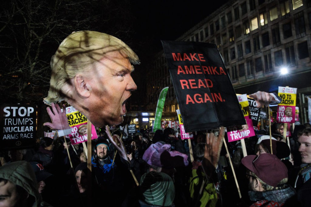 LONDON, ENGLAND - JANUARY 20: Protesters wave placards during a demonstration against U.S. President Donald J. Trump outside the United States Embassy in London on January 20, 2017 in London, England. Mr Trump has become the 45th President of the United States following an inauguration ceremony in Washington, DC today. (Photo by Jack Taylor/Getty Images)