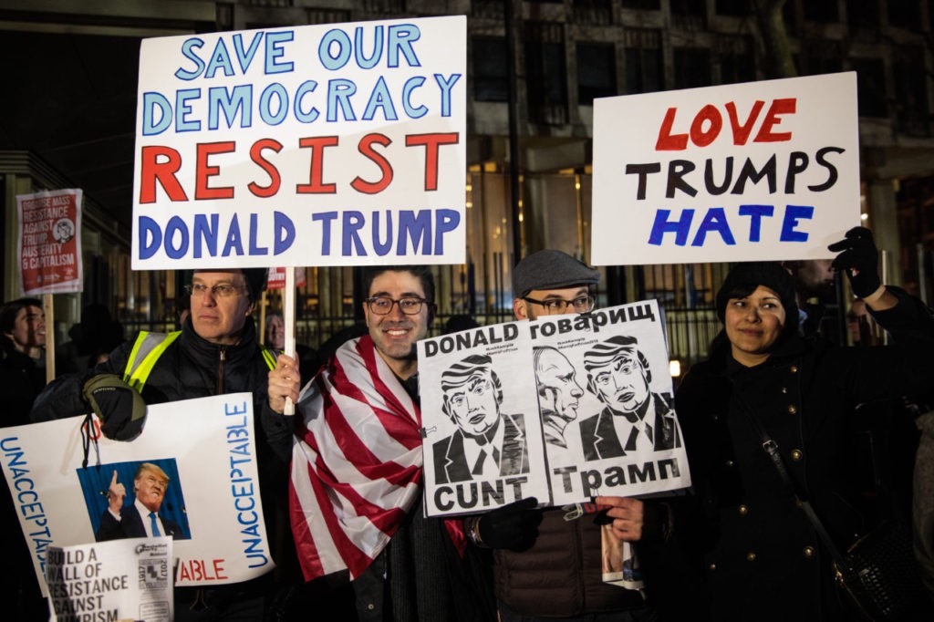 LONDON, ENGLAND - JANUARY 20: Protesters are pictured holding placards during a demonstration against U.S. President Donald J. Trump outside the United States Embassy in London on January 20, 2017 in London, England. Mr Trump has become the 45th President of the United States following an inauguration ceremony in Washington, DC today. (Photo by Jack Taylor/Getty Images)