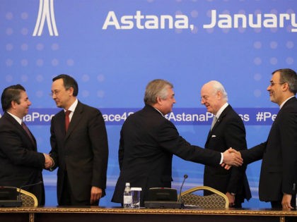 Turkish Foreign Ministry Deputy Undersecretary Sedat Onal, left, and Kazakh Foreign Minister Kairat Abdrakhmanov shake hands, as Russia's special envoy on Syria Alexander Lavrentiev and Iran's Deputy Foreign Minister Hossein Jaber Ansari, right, shake hands and UN Syria envoy Staffan de Mistura stand after the final statement following the talks …