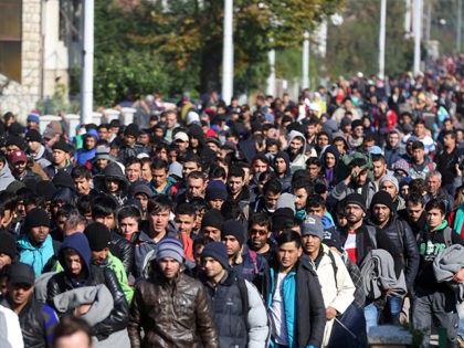 Around 2000 migrants who arrived by train, walk near the border town of Kljuc Brdovecki, on October 24, 2015, to cross the Croatia-Slovenia border. Crowds of refugees and other migrants camp by roads in western Balkan countries in worsening autumn weather after Hungary sealed its borders with Serbia and Croatia, …