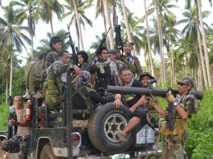 This photo taken on July 29, 2016 shows Muslim rebels from the Moro National Liberation Front (MNLF) aboard a vehicle gathering at a village as they await orders from their leader Nur Misuari in an effort to help rescue remaining hostages of the extremist Abu Sayyaf group in Kalingalang Caluang …