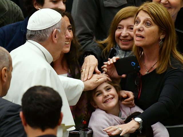 Pope Francis blesses a child during his weekly general audience at the Paul VI audience Hall on December 7, 2016 in Vatican. / AFP / VINCENZO PINTO (Photo credit should read VINCENZO PINTO/AFP/Getty Images)