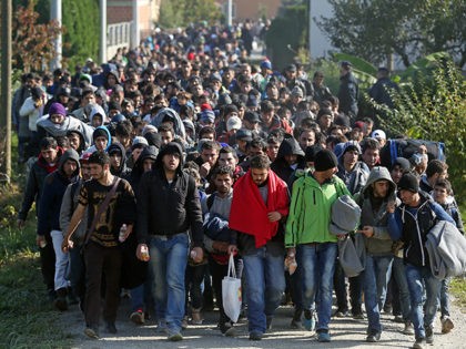 Around 2000 migrants who arrived by train, walk near the border town of Kljuc Brdovecki, on October 24, 2015, to cross the Croatia-Slovenia border. Crowds of refugees and other migrants camp by roads in western Balkan countries in worsening autumn weather after Hungary sealed its borders with Serbia and Croatia, …