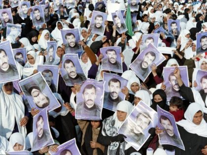 Followers of Palestinian Islamic movement Hamas hold pictures of Yahya Ayash during a rally in Gaza City on January 12, 1996 to commemorate the killing of Yahia Ayash who was the alleged mastermind of suicide bomb attacks against Israel. Hamas militant Yehiya Ayash, nicknamed 'the engineer', was killed on January …
