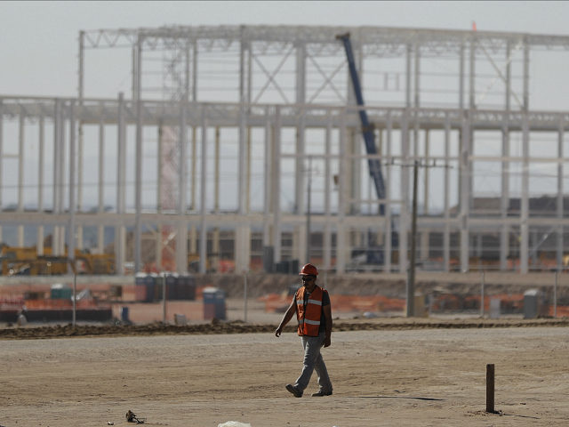 A man walks past a nearly deserted construction site Wednesday in Villa de Reyes, San Luis Potosi, Mexico, as workers shut down operations and remove equipment from the site of a canceled $1.6 billion Ford plant. Ford's cancellation, which costs the region thousands of projected jobs, has sounded alarms in …