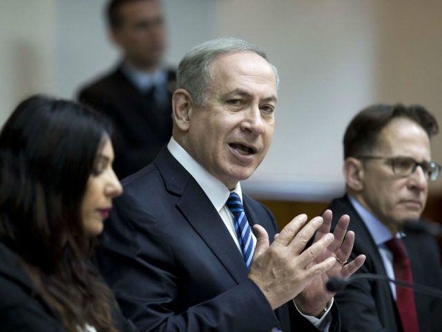 Israeli Prime Minister Benjamin Netanyahu (C) chairs the weekly cabinet meeting at his off