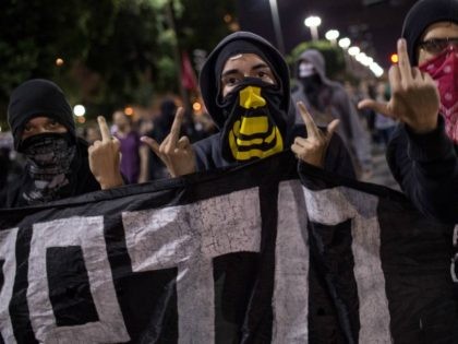 Members of the anarchist group Black Bloc protest against the FIFA World Cup in Rio de Janeiro, Brazil, on May 30, 2014. Brazil has been hit by a wave of strikes and protests against the more than $11 billion being spent on the tournament in a country that desperately needs …