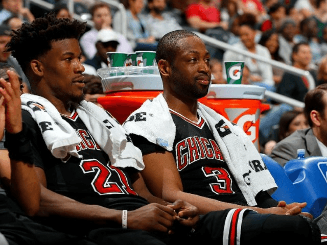 Jimmy Butler (L) and Dwyane Wade of the Chicago Bulls look on from the bench during the ga