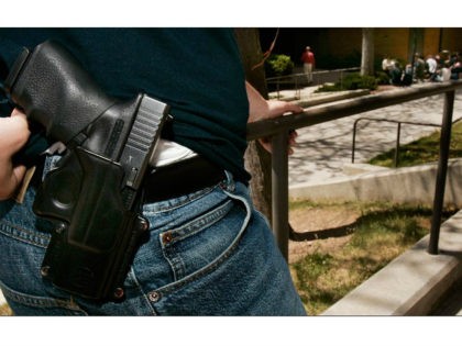 Brent Tenney displays his Glock 9mm semi-automatic handgun on the University of Utah campus where he is a student Wednesday, April 25, 2007, in Salt Lake City. Tenney says he feels relatively safe when he goes to class at the university, but the 24-year-old business major doesn't want to take …