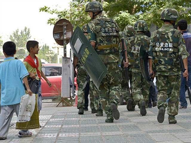 Chinese paramilitary policemen patrol a street in Kashgar city, northwest Chinas Xinjiang Uygur Autonomous Region, 23 July 2014. Chinese police shot dead dozens of knife-wielding attackers on Monday (28 July 2014) morning after they staged assaults on two towns in the western region of Xinjiang, the official Xinhua news agency …
