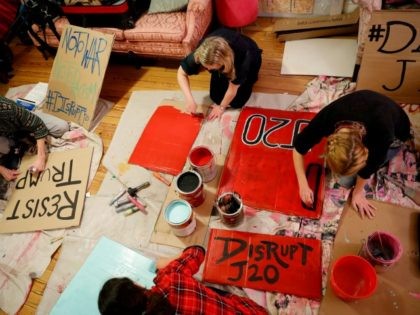Activists gather to make signs for demonstrations against the upcoming inauguration of Donald Trump January 11, 2017 in Washington, DC. The Inauguration is expected to bring thousands of activists and supporters to Washington. (Photo by Aaron P. Bernstein/Getty Images)