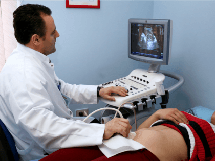 A pregnant Albanian woman lies on a bed while doctor looks at the foetus on a monitor as he carries out a sonogram on April 20, 2015 in Tirana. Selective abortions remain a common practise in Albania and several Balkan countries, where an imbalance between boys and girls at birth …