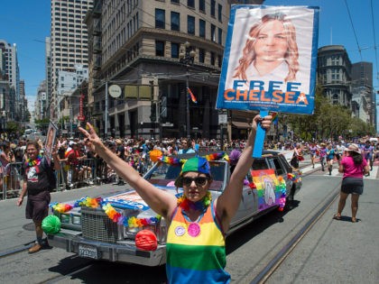 Abigail Edward holds up a sign advocating the release of WikiLeaks whistle blower Chelsea Manning along the Gay Pride parade route in San Francisco, California on Sunday, June, 26, 2016. / AFP / Josh Edelson (Photo credit should read JOSH EDELSON/AFP/Getty Images)