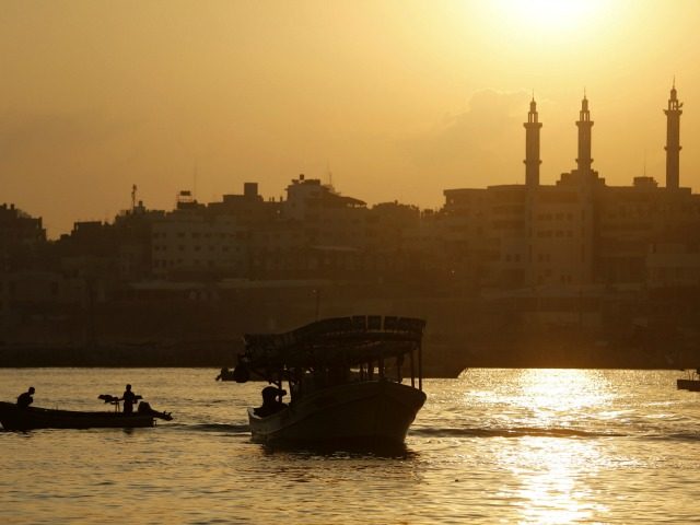 Palestinian fishermen sail their boats at Gaza's seaport in Gaza City early on August