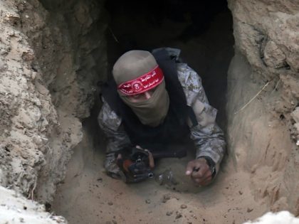 A Palestinian militant of the National Resistance brigades, the armed wing of the Democratic Front for the Liberation of Palestine (DFLP), gets out of a tunnel during a graduation ceremony in Rafah, in the southern Gaza Strip, on November 4, 2016. / AFP / SAID KHATIB (Photo credit should read …