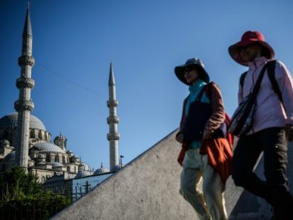 Women walk near the new mosque in Eminonu district in Istanbul, on June 9, 2016. Turkey ha