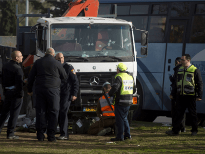 Israeli security forces and emergency personnel gather at the site of a vehicle-ramming attack on January 8, 2017 in Jerusalem, Israel. Four israeli soldiers were killed and 13 wounded after an industrial truck driven by a Palestinian man, rammed into a group of people. (Photo by Lior Mizrahi/Getty Images)