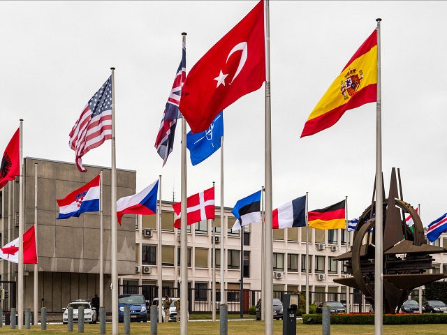 NATO country flags wave outside NATO headquarters in Brussels on Tuesday July 28, 2015. Fo