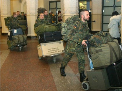 German soldiers walk after arriving at the airport Vilnius, Lithuania, on January 24, 2017. A group of German officers landed in the Baltic state's capital Vilnius to coordinate the deployment of a 1,200-strong battalion that will include forces from several NATO members. / AFP / Petras Malukas (Photo credit should …