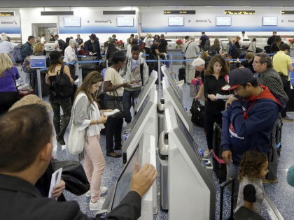 Passengers prepare to check in at Miami International Airport, Wednesday, Nov. 23, 2016, in Miami. Almost 49 million people are expected to travel 50 miles or more for the holiday, the most since 2007, according to AAA. (AP Photo/Alan Diaz)