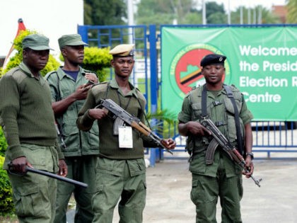 Zambian police officers stand guard outside the Presidential Election results centre, Mulungushi International Conference Centre, in Lusaka on January 21, 2015. Zambian police fired teargas to disperse around 100 supporters of the leading opposition candidate in Zambia's presidential elections on January 21 as they waited for results of the vote. …