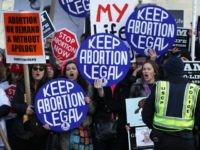WASHINGTON, DC - JANUARY 22: Pro-choice activists shout slogans before the annual March for Life passes by the U.S. Supreme Court January 22, 2015 in Washington, DC. Pro-life activists gathered in the nation's capital to mark the 1973 Supreme Court Roe v. Wade decision that legalized abortion. (Photo by Alex …