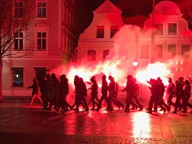 Masked far-right demonstrators hold illegal protest against north African migrants in German city of Cottbus,