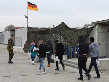 Migrants walk to get the first registration at the registration point for asylum seekers i