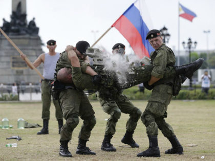 A Russian Marine uses a hammer to break a brick on top of his comrade's stomach during a Capability Demonstration at Manila's Rizal Park, Philippines on Thursday, Jan. 5, 2017. Russia is eyeing naval exercises with the Philippines and deployed two navy ships for a goodwill visit to Manila as …