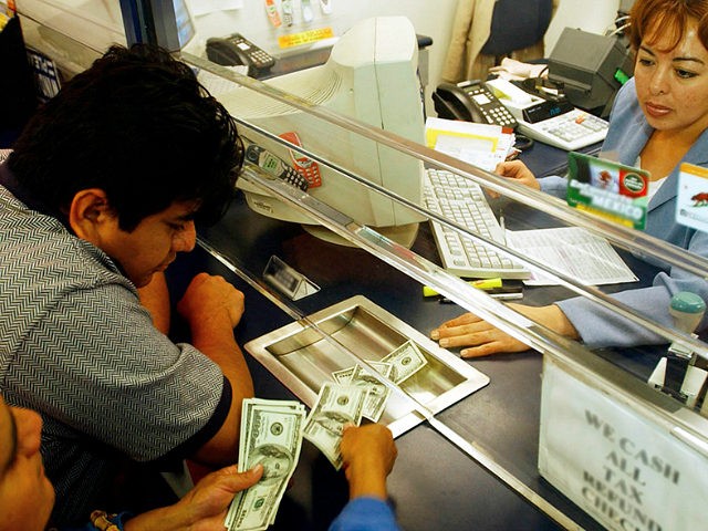Alfonsa Morales, left, counts money she and her son Hector Gonzalez are handing to Eteldina Romero to be sent to Mexico, at Popular Cash Express #2 in Los Angeles, Monday, Dec. 30, 2002. Morales and Gonzalez sent $650 to a friend in a small village in Oaxaca as a New â€¦