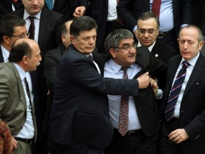 Ruling party and opposition Turkish lawmakers scuffle during a debate over a controversial