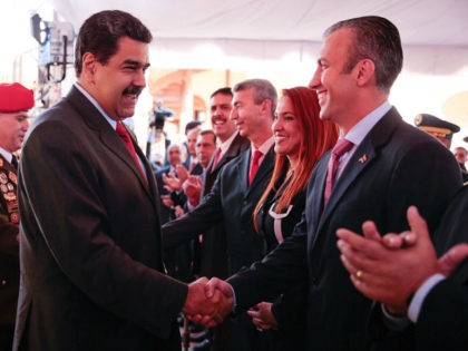 Venezuela's President Nicolas Maduro (C) shakes hands with Venezuela's new Vice-President Tarek El Aissami (R) during a meeting with ministers at 4F military fort in Caracas, Venezuela January 4, 2017. Miraflores Palace/Handout via REUTERS