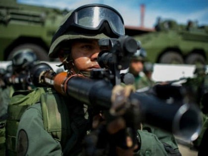 TOPSHOT - Venezuelan soldiers prepare to embark for military maneuvers at the port of La G