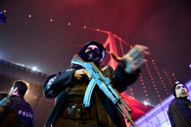 A Turkish police officers stands guard on the site of an armed attack at the Reina nightcl