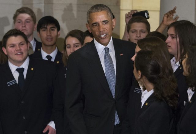 US President Barack Obama greets Senate pages as he leaves a meeting with the House and Se