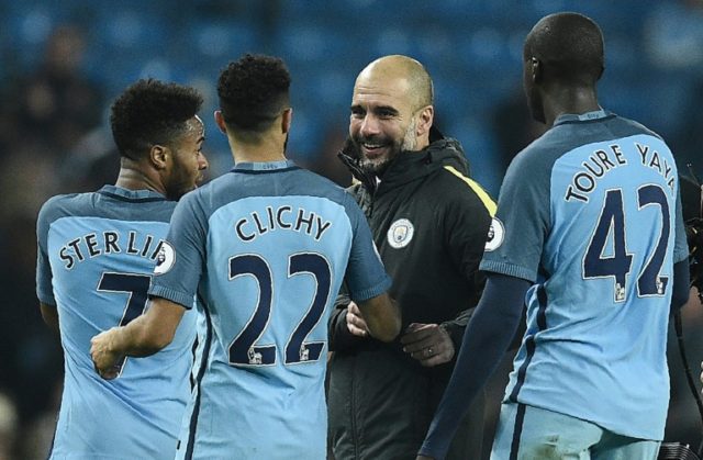 Manchester City's manager Pep Guardiola (C) congratulates Raheem Sterling, Gael Clichy and