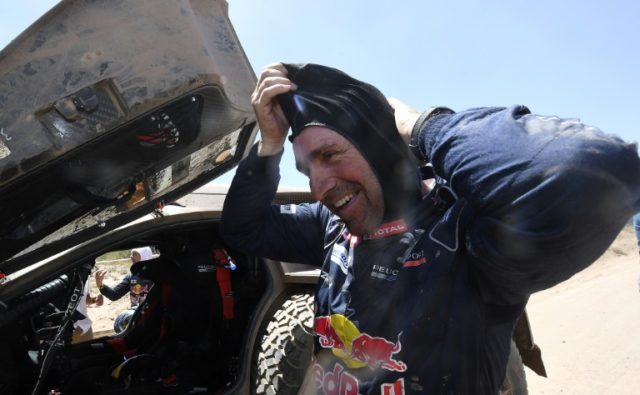 Peugeot's French pilot Stephane Peterhansel smiles at the end of Stage 2 of the 2017 Dakar