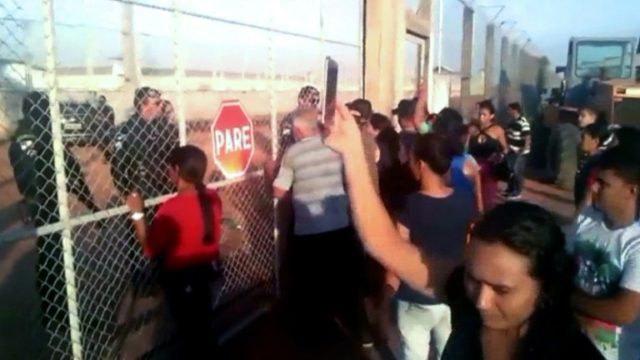 Video grab released by Folha de Boa Vista shows relatives of inmates gathering outside the
