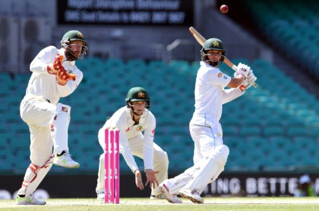 Pakistan batsman Yasir Shah (R) cuts the ball away as Australia's wicketkeeper Matthew Wad