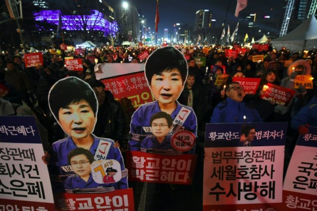 Protesters carry portraits of South Korea's President Park Geun-Hye during a protest deman
