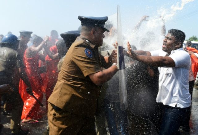 Sri Lankan police use water canons to disperse activists and Buddhist monks during a prote